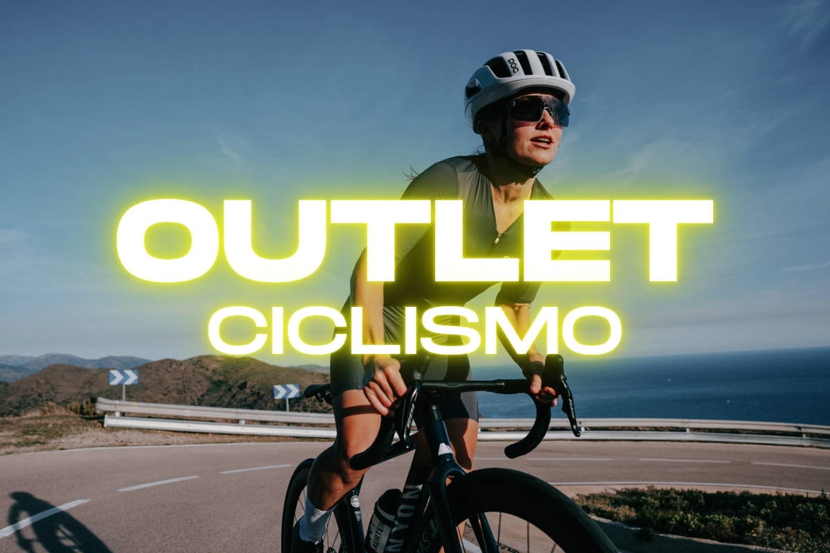 Female cyclist in helmet riding a road bike on a coastal highway with neon 'OUTLET CICLISMO' text overlay