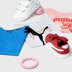 Abbigliamento Puma che include magliette blu e rosa, sneakers bianche e rosse, un anello rosa e due palloni. Ambientato su uno sfondo neutro.