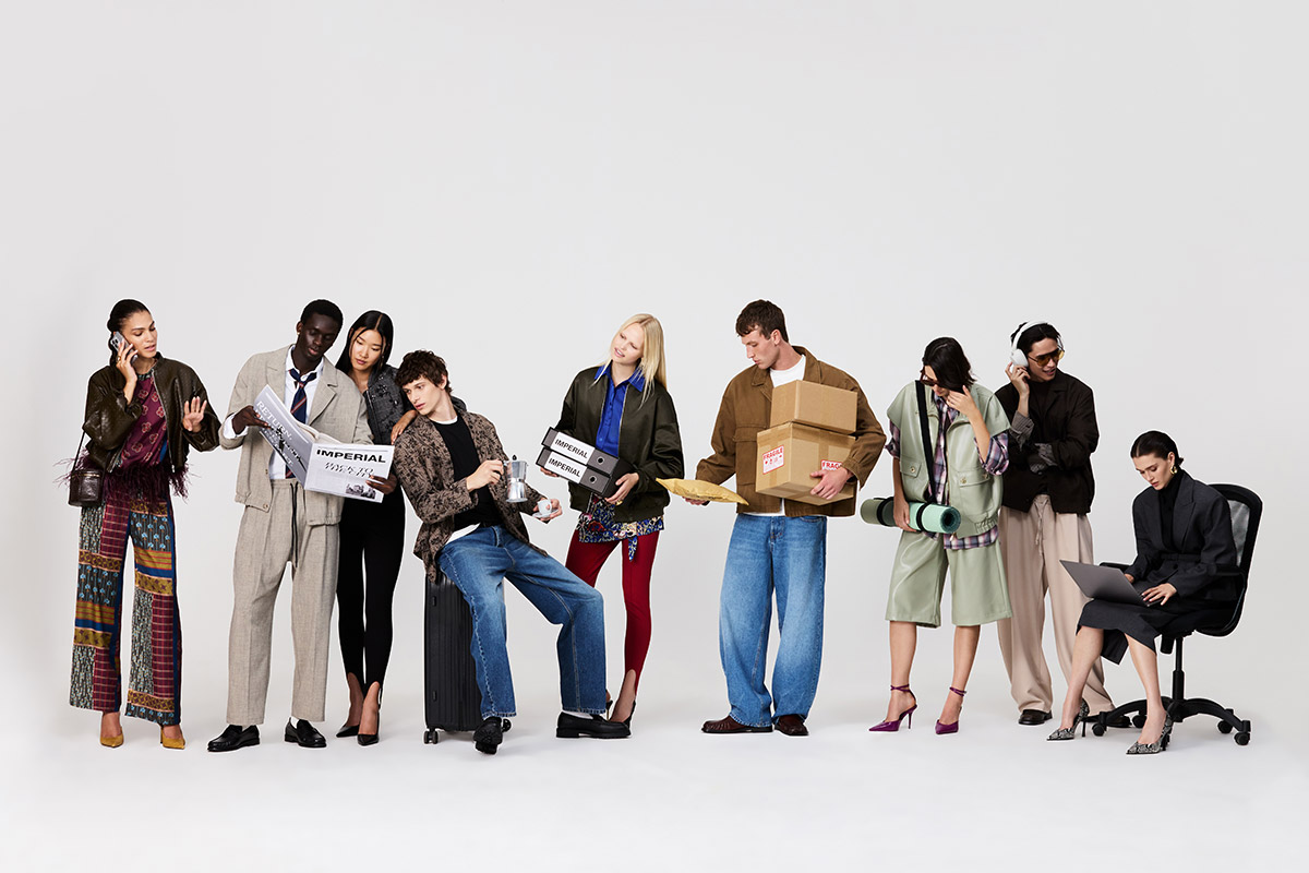 Diverse group of young adults in mixed fashion styles posing with newspapers, luggage, parcels, yoga mat, headphones and a laptop