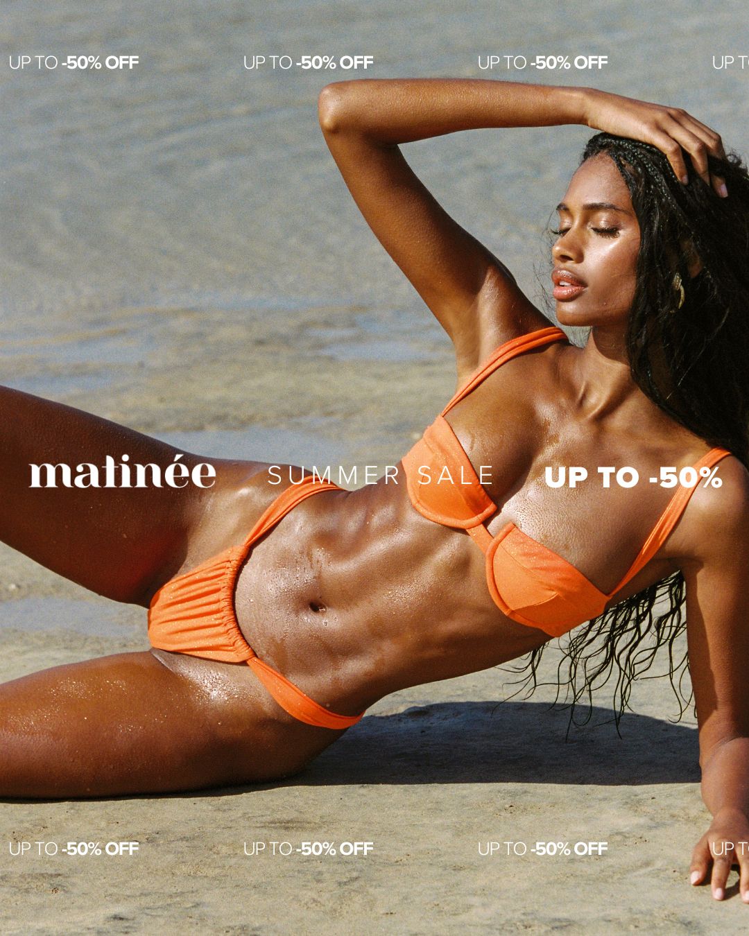 Model in orange bikini reclining on wet beach sand for matinée summer sale banner, up to 50% off