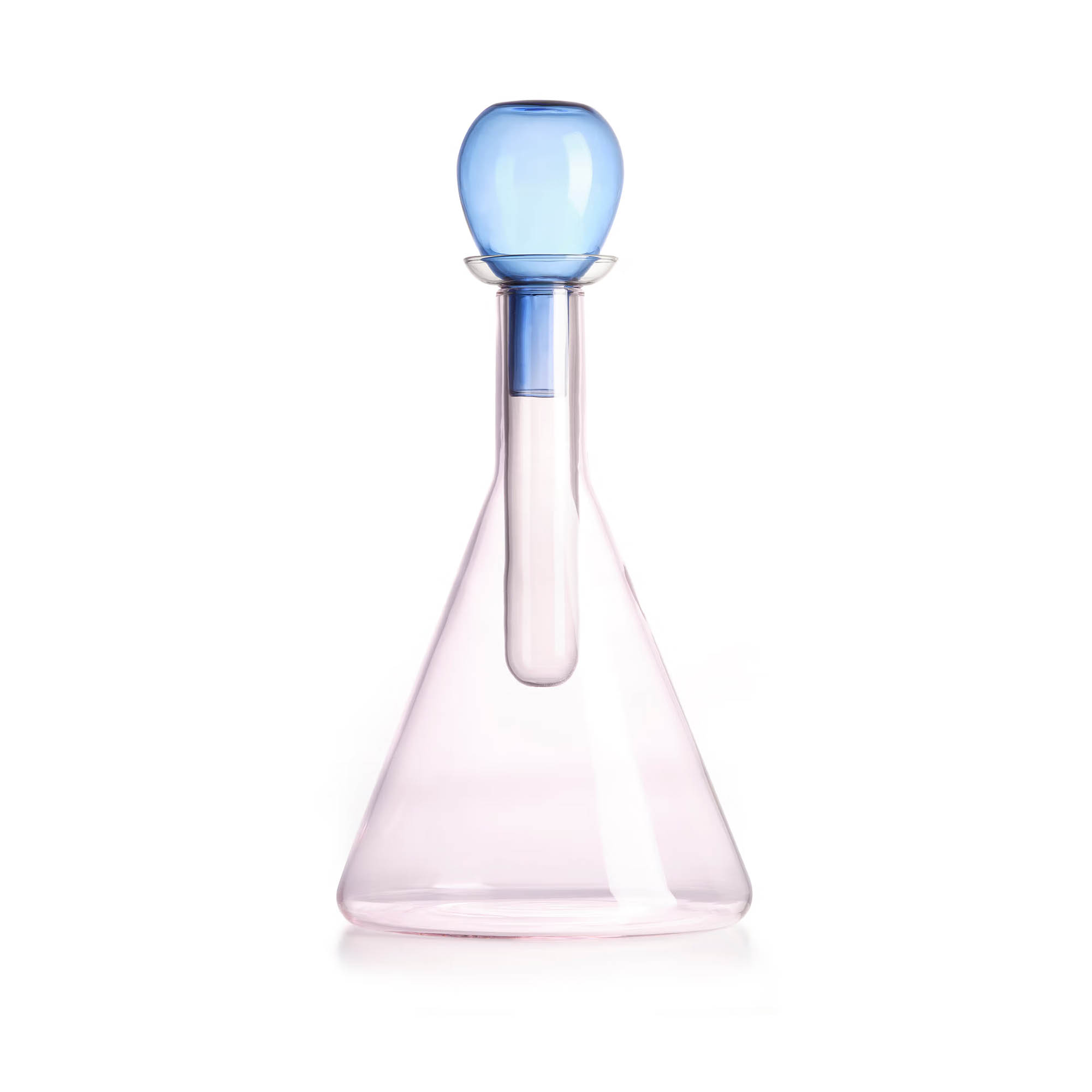 Pink-tinted conical glass decanter with inner tube and round blue stopper on white background