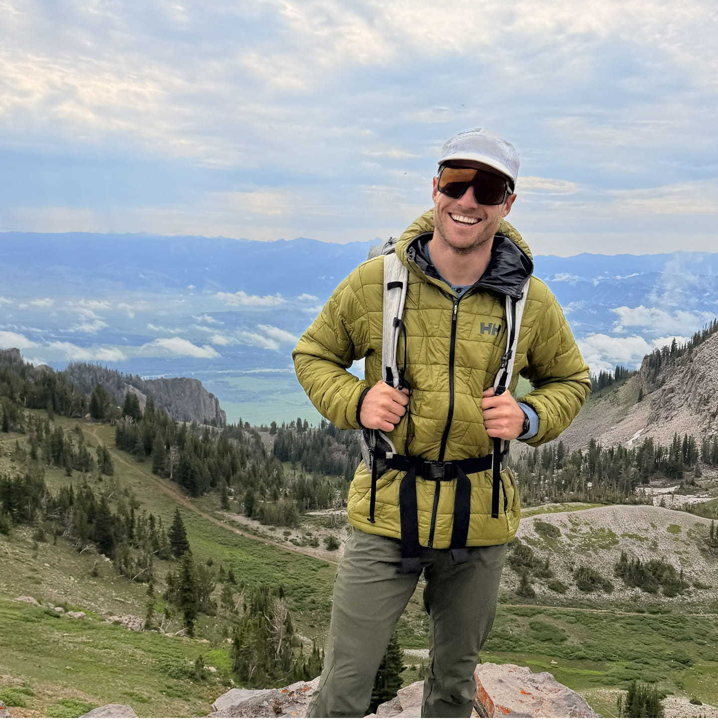 Man hiking in the mountains wearing a Helly Hansen jacket