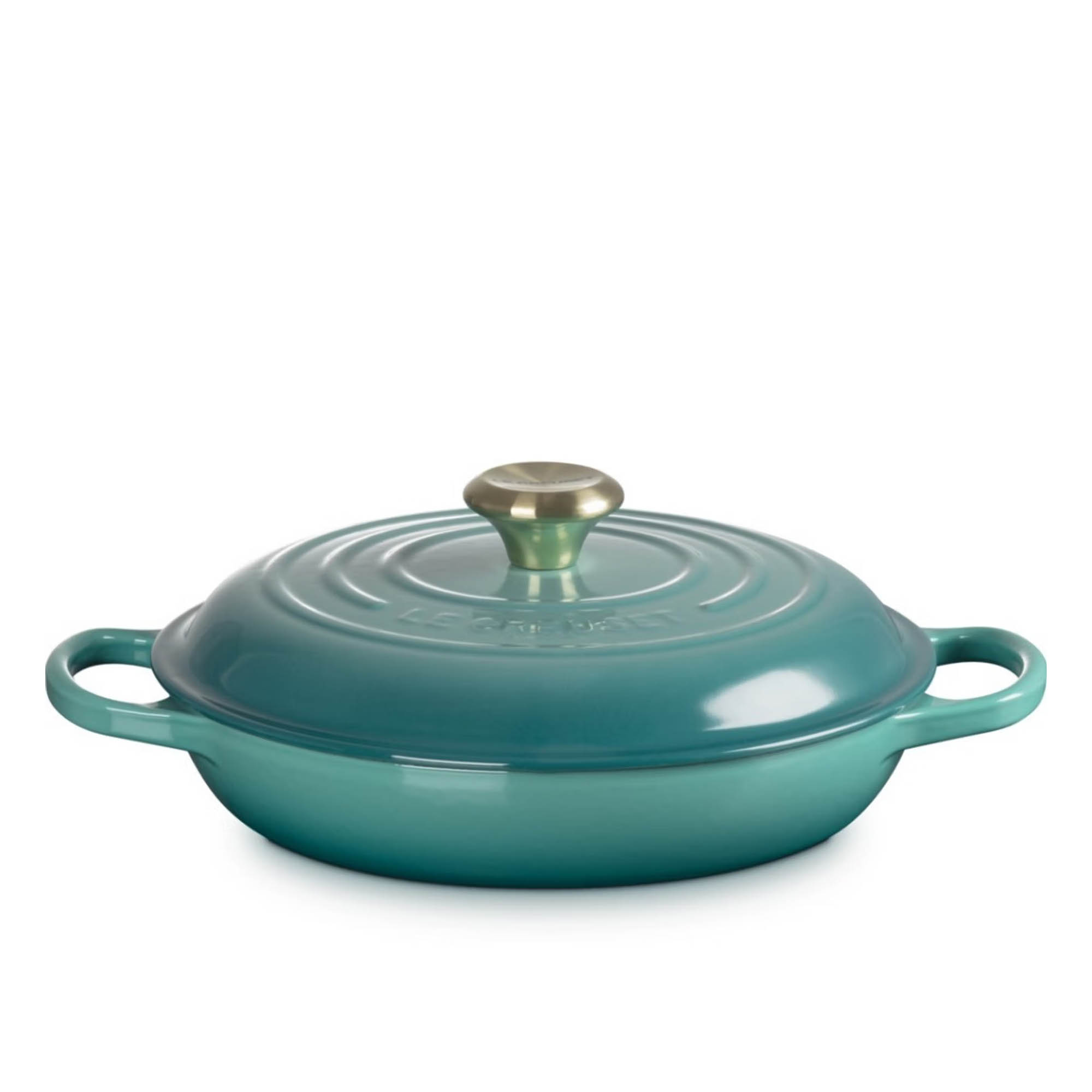 Teal enamelled cast-iron shallow casserole dish with lid, brass knob and twin handles on white background