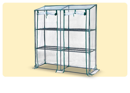 Compact three-shelf portable greenhouse with green metal frame and clear zip-up PVC cover for balcony or patio plants