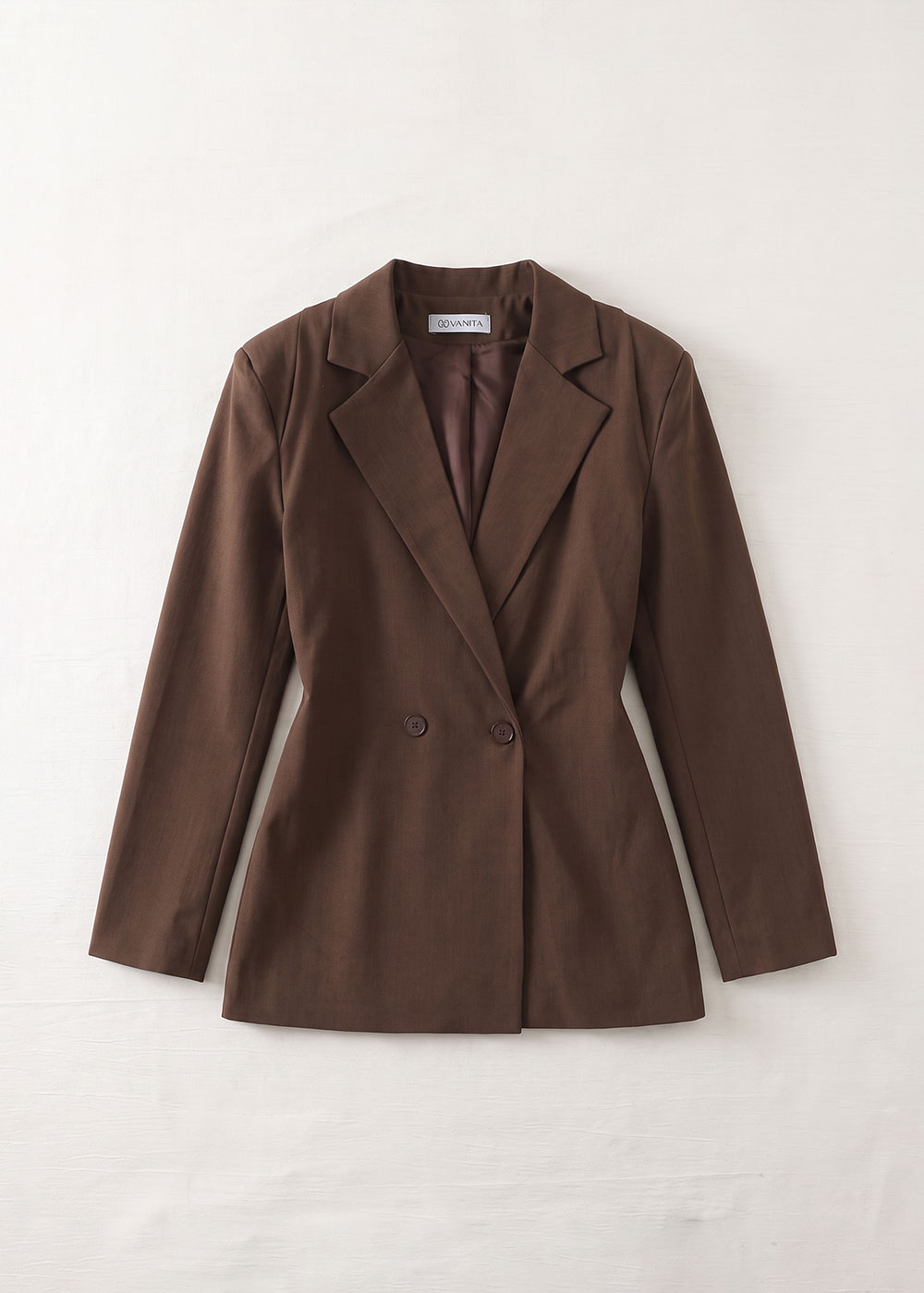 Brown women's double-breasted tailored blazer laid flat on white background, notch lapels and long sleeves