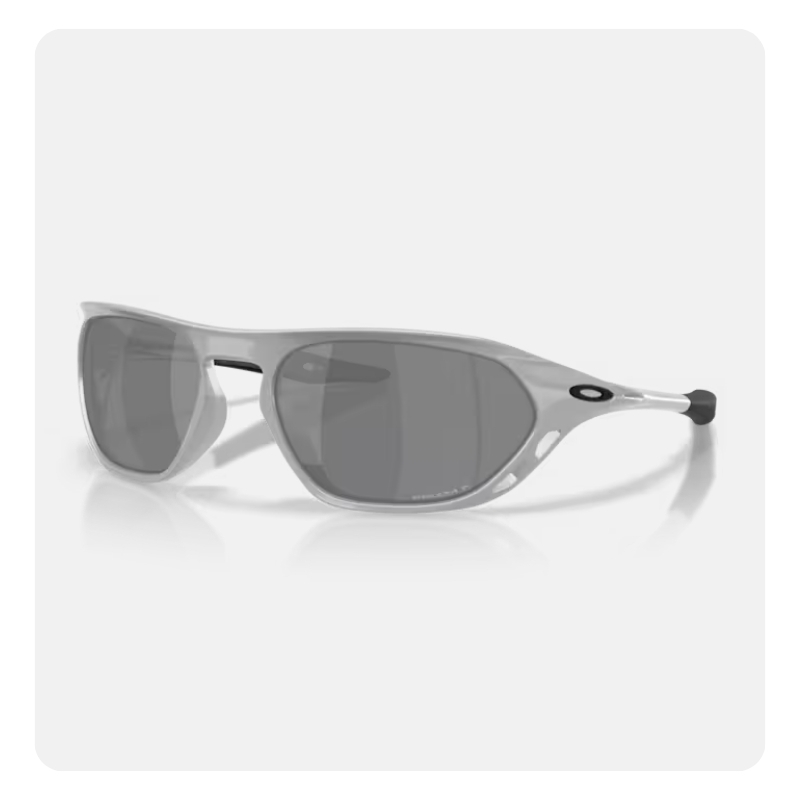 Grey wraparound sports sunglasses with dark polarised lenses and oval logo on the temple, reflected on a white surface