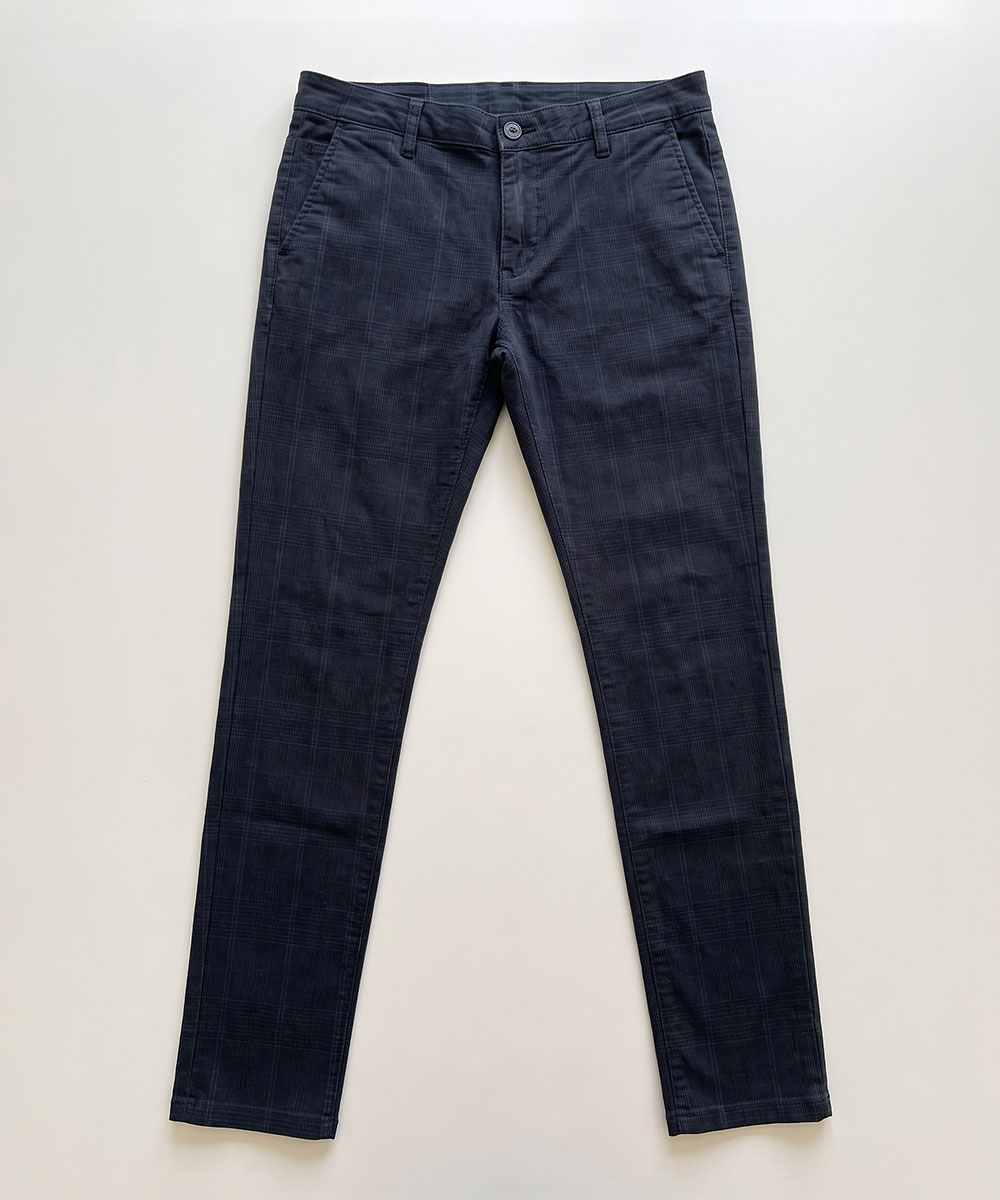 Navy slim-fit men's chinos with subtle checked texture, flat-lay on white background showing front view with button and side pockets