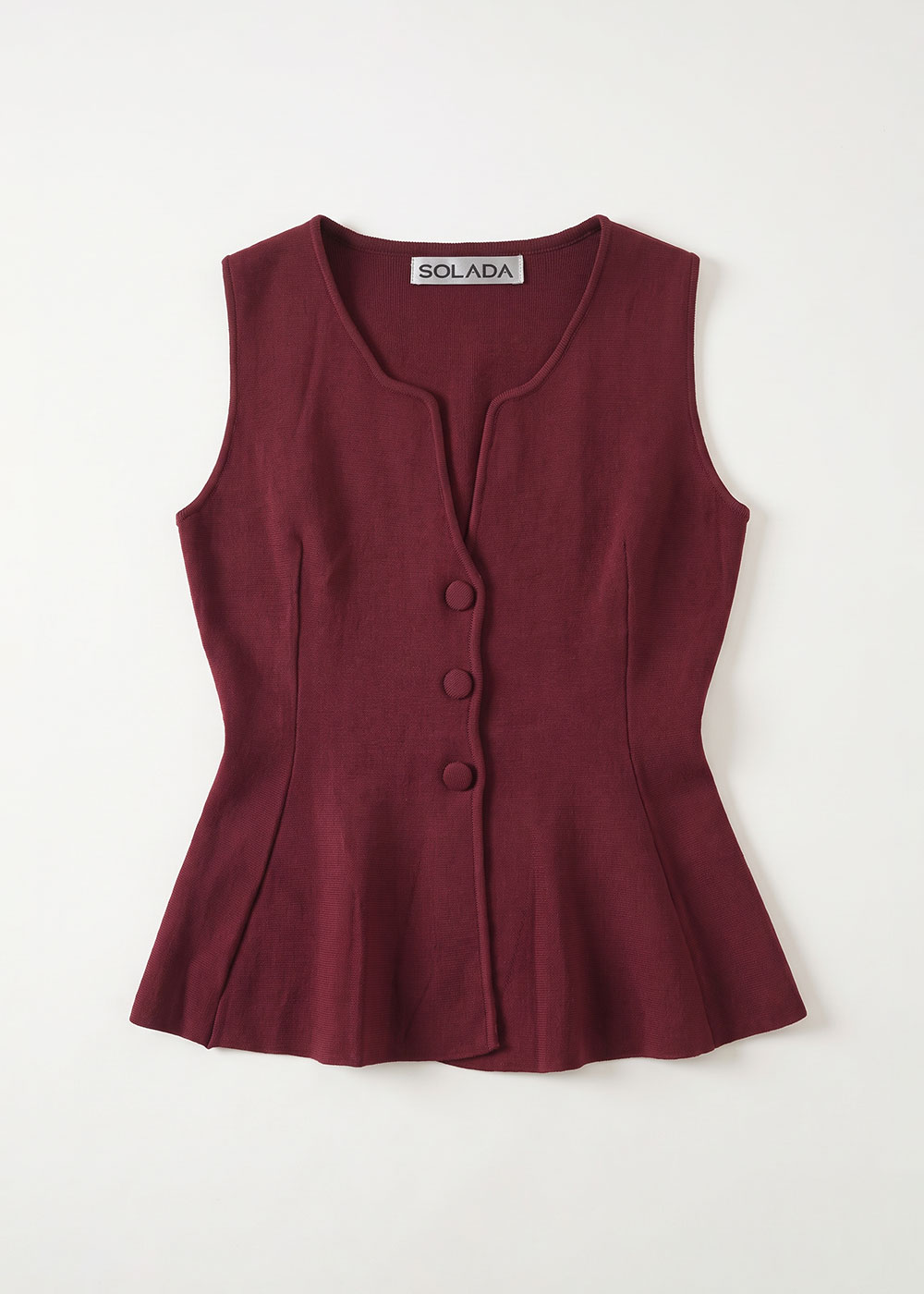 Burgundy sleeveless peplum top with three fabric-covered buttons and round neckline, labelled "SOLADA", on a white background