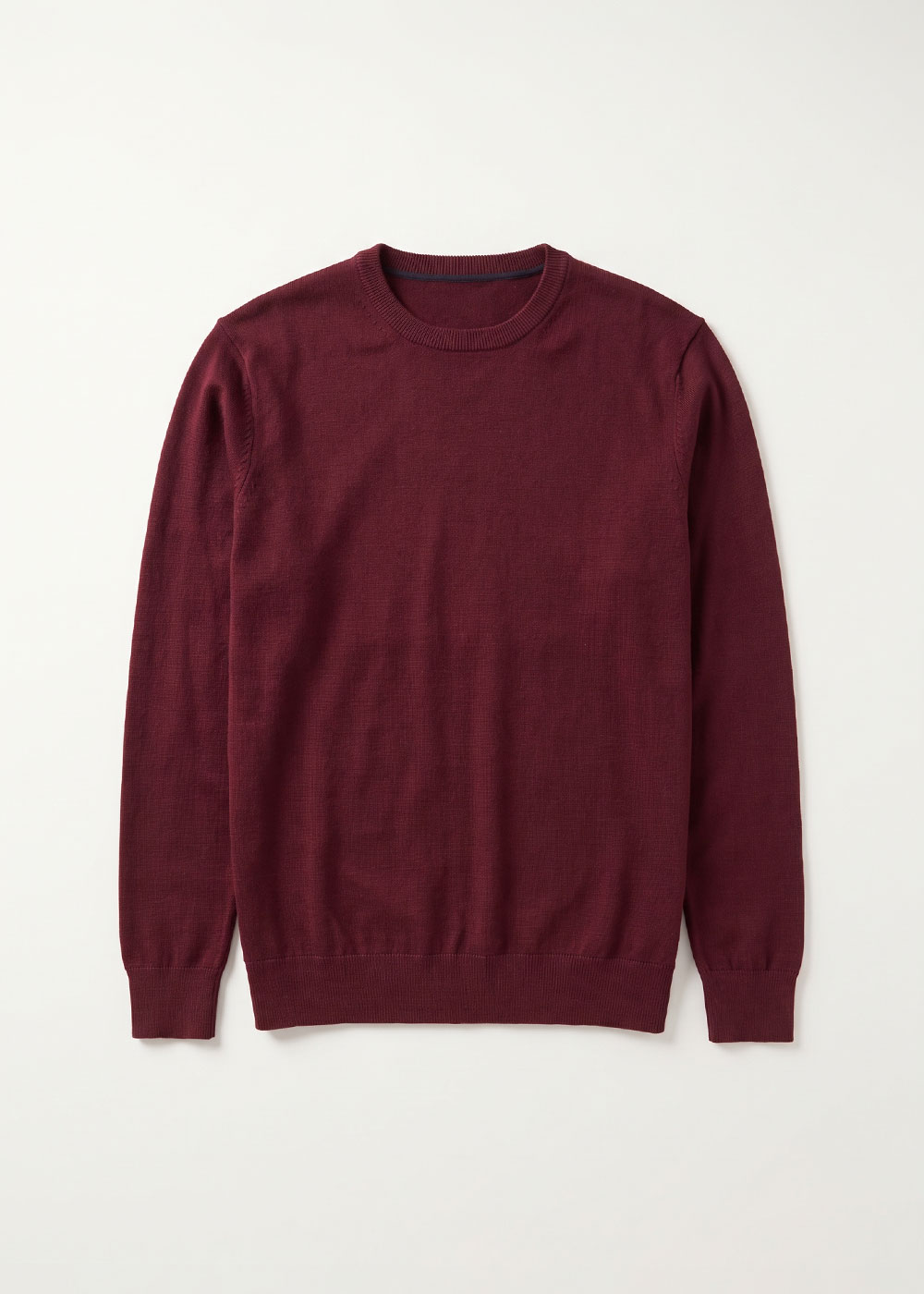 Burgundy crew-neck merino wool jumper laid flat on white background — men's lightweight long-sleeve knit