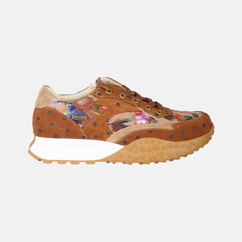 Brown suede women's trainer with floral fabric panels, navy polka dots, white midsole and gum treaded sole, side view