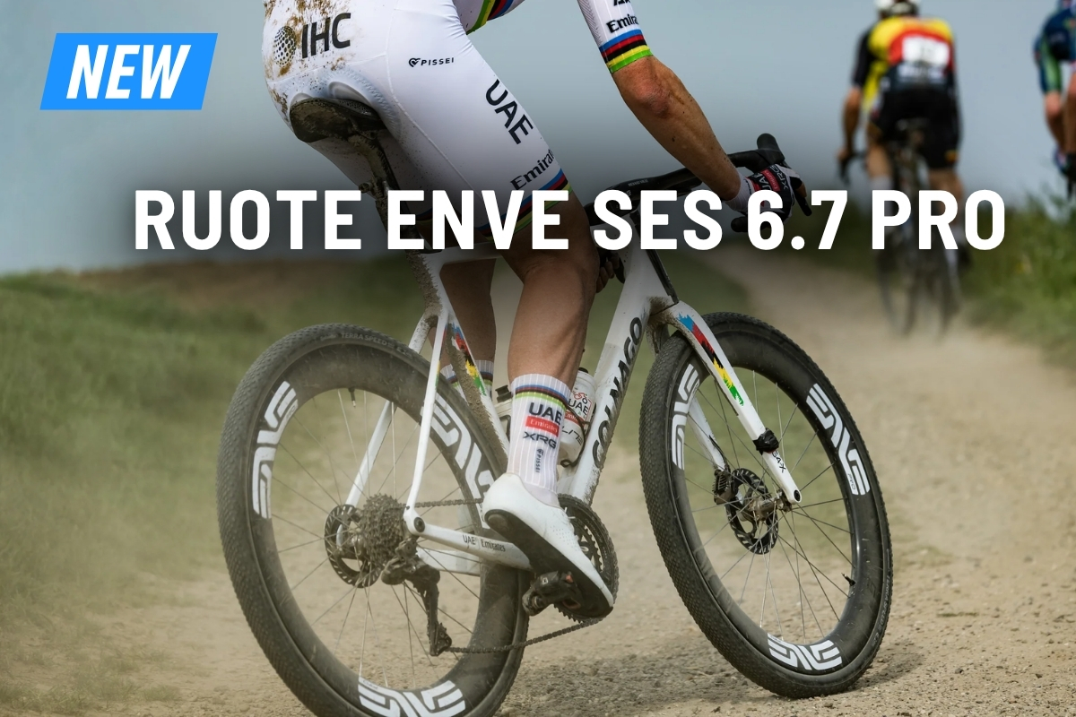 Close-up of cyclist riding on a gravel road showing ENVE SES 6.7 Pro carbon wheels, rear drivetrain and dirt spray