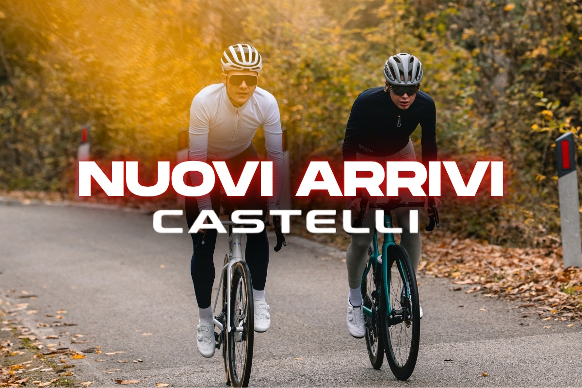 Two cyclists riding on a tree-lined road in autumn wearing helmets and sunglasses; overlay text 'NUOVI ARRIVI CASTELLI'