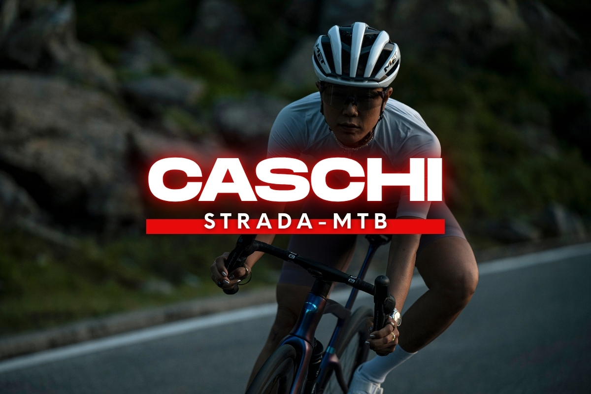 Road cyclist wearing a white helmet and sunglasses on a bike on a mountain road, with 'CASCHI STRADA‑MTB' logo overlay.