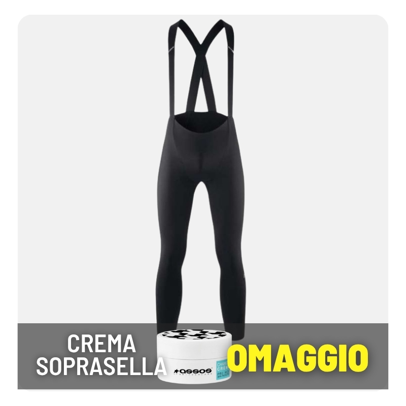Black cycling bib tights with crossed shoulder straps on white background and a promotional cream jar labelled 'OMAGGIO' in the foreground