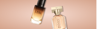 Due flaconi di profumo nelle calde tonalità dell'oro e del rosa, su uno sfondo chiaro.