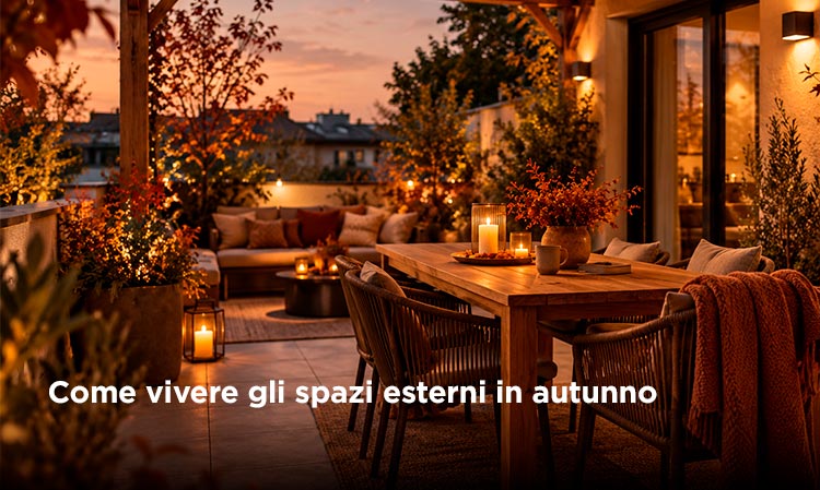 Cosy autumn rooftop terrace at dusk with a wooden dining table, candles, cushions and warm ambient lighting for outdoor entertaining