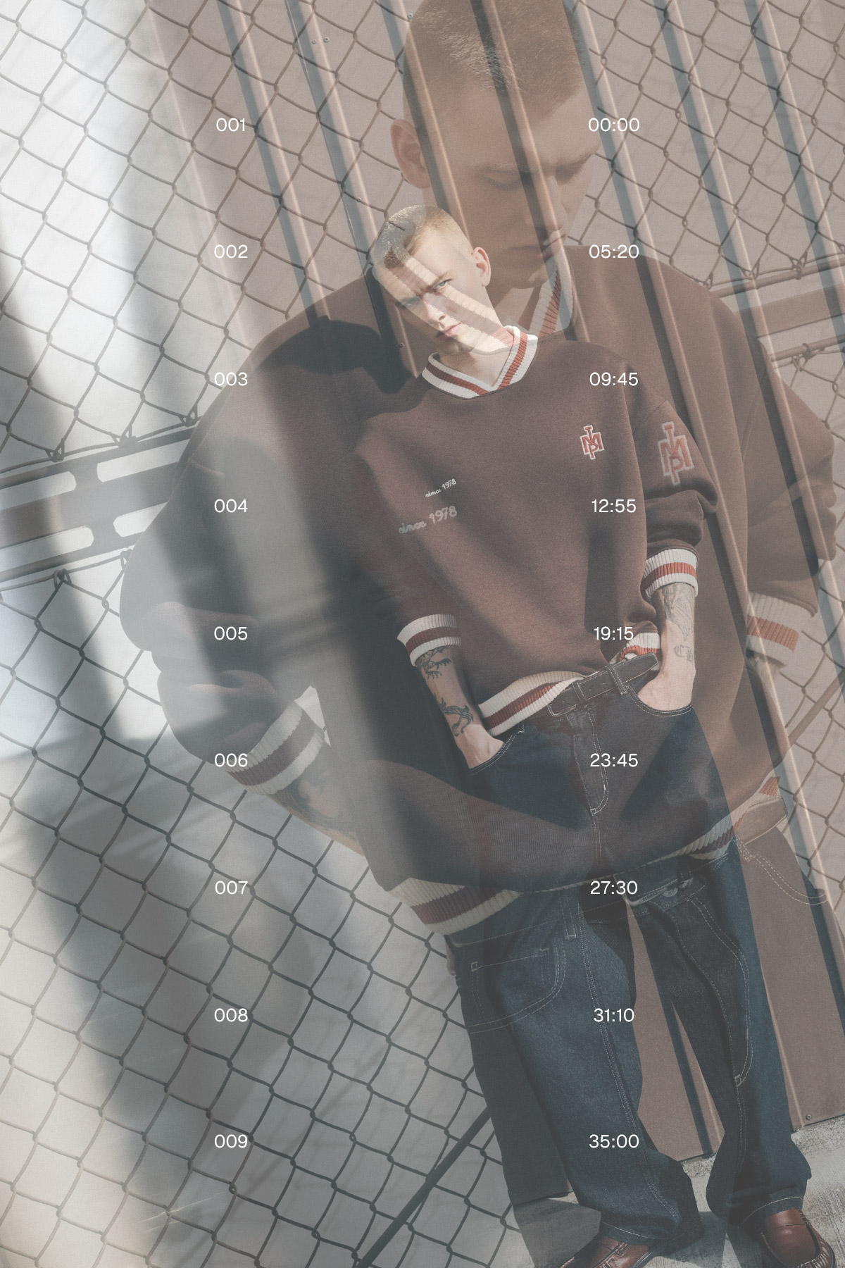 Double-exposed photo of a young man in an oversized jumper and jeans leaning by a chain-link fence, tattoos visible and timestamps overlaid