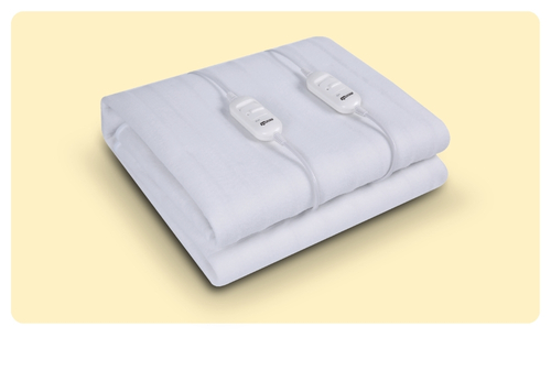 Folded white electric blanket with two wired controllers on cream background — heated throw for adjustable warmth