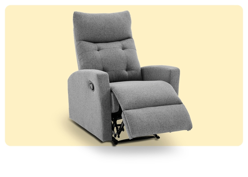 Grey fabric reclining armchair with padded tufted back, extended footrest and side lever on pale background