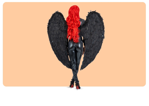 Rear view of person with long red hair wearing black leather outfit and large black feather wings against a peach background