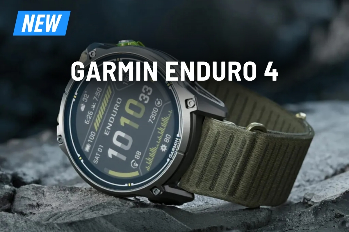Garmin Enduro 4 rugged GPS smartwatch with green fabric strap resting on rock, large display showing fitness metrics and time