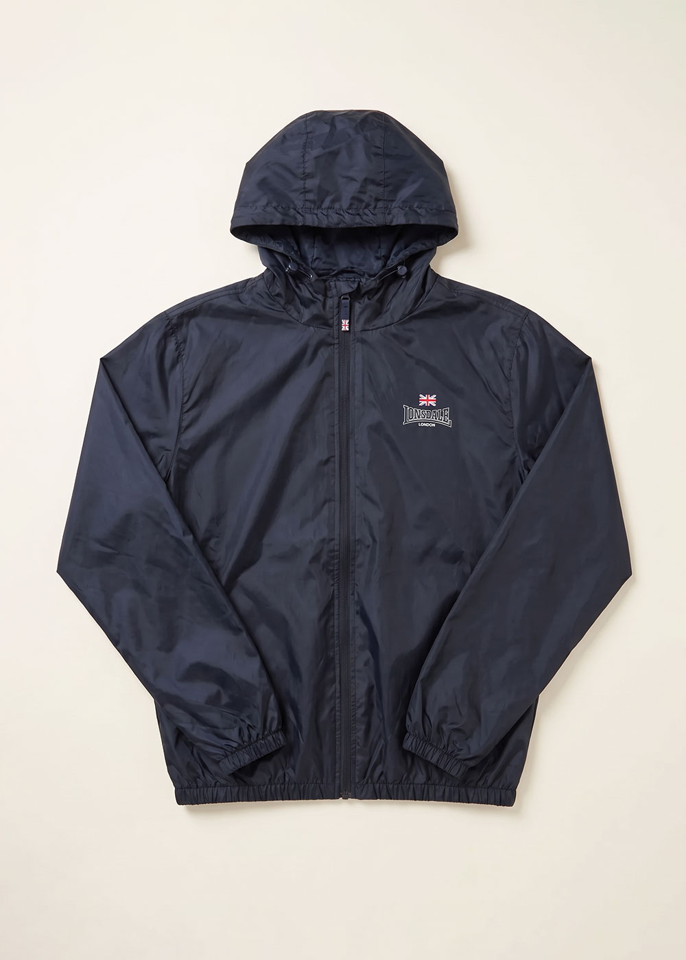 Navy hooded lightweight water-resistant jacket with full zip and elasticated cuffs, small Union Jack logo on chest, laid flat on cream background