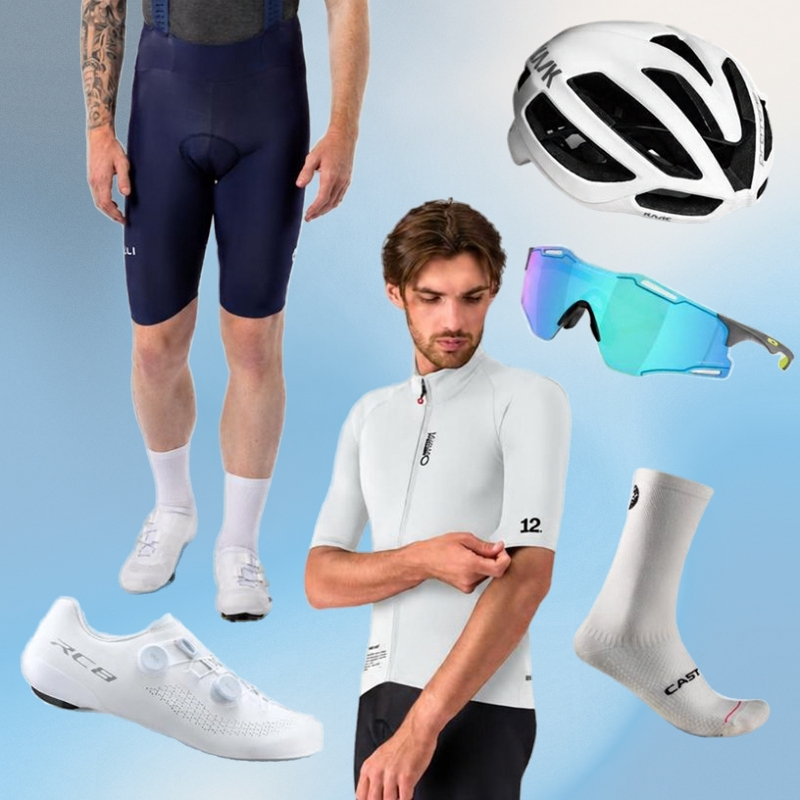Men's white cycling kit with aero helmet, mirrored sunglasses, short-sleeve white jersey, navy bib shorts, white road shoes and socks