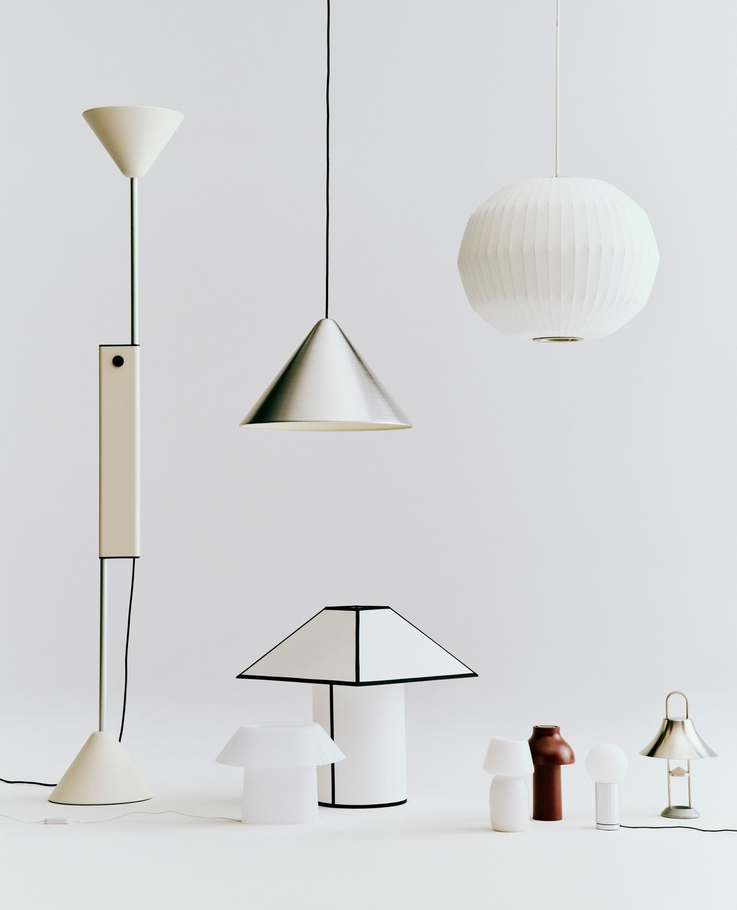 Minimalist arrangement of modern lamps and pendants on a white background, assorted floor and table lights