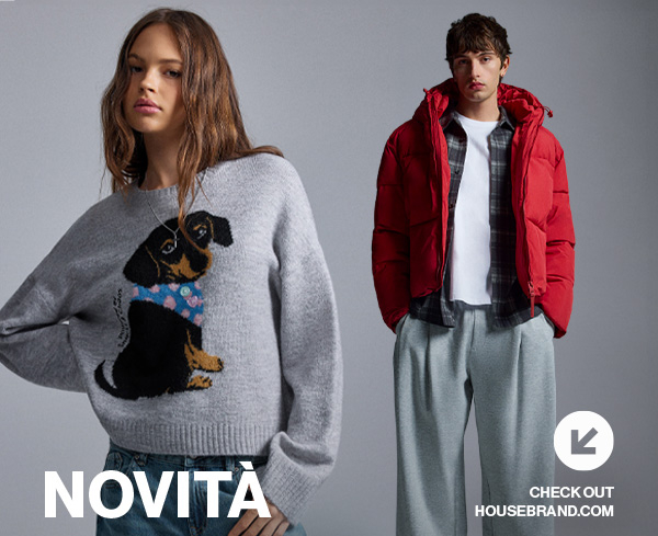 NOVITÀ. Donna con maglione grigio con un cane e uomo con giacca rossa.