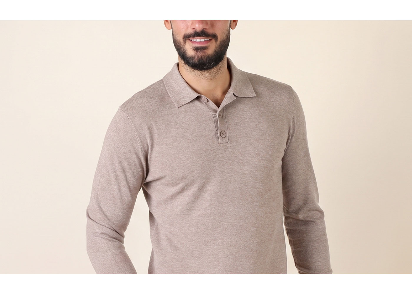 Male model wearing a beige long-sleeve polo sweater with button placket, smiling against a neutral background