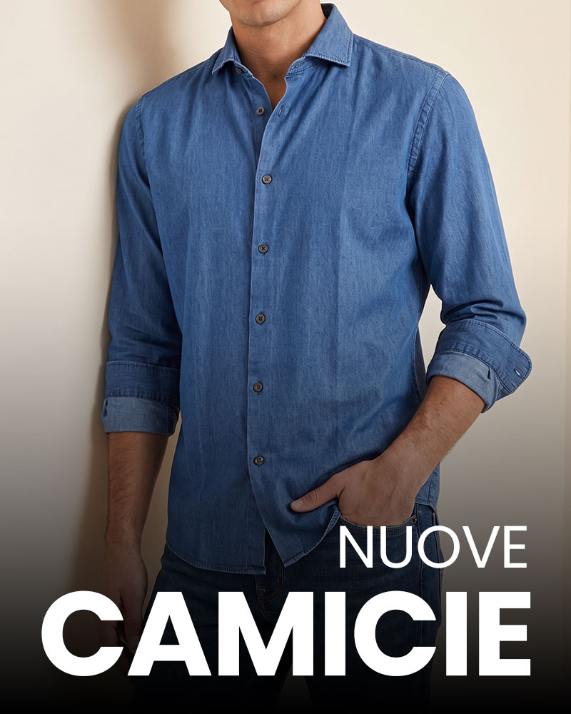 Man wearing blue denim long-sleeve shirt with sleeves rolled and hand in pocket; promotional text 'NUOVE CAMICIE' visible