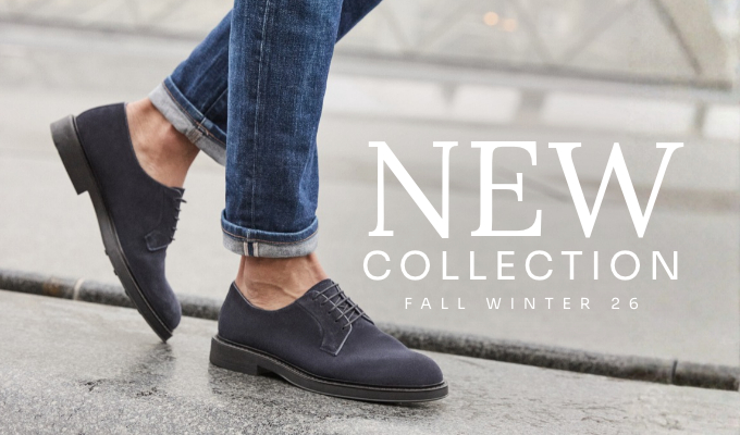Men's navy suede oxford shoes on pavement with rolled jeans; overlay text 'New Collection Fall Winter 26'