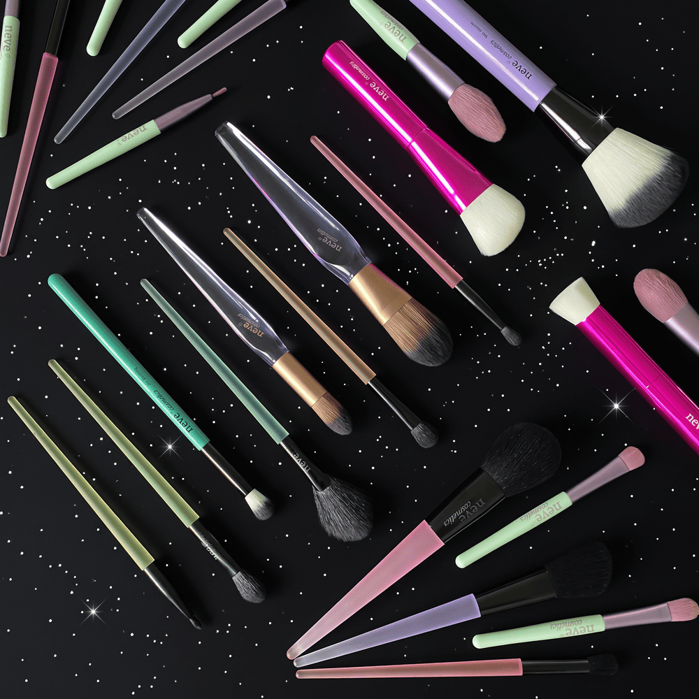 Colourful makeup brushes arranged on black starry background, assorted sizes for foundation and eyeshadow application