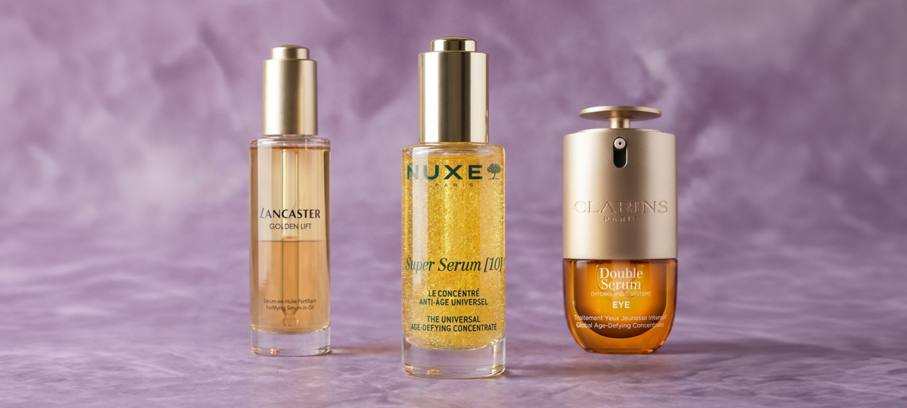 Sieri anti-aging Lancaster, NUXE e Clarins su sfondo viola, per una skincare ad alte prestazioni.