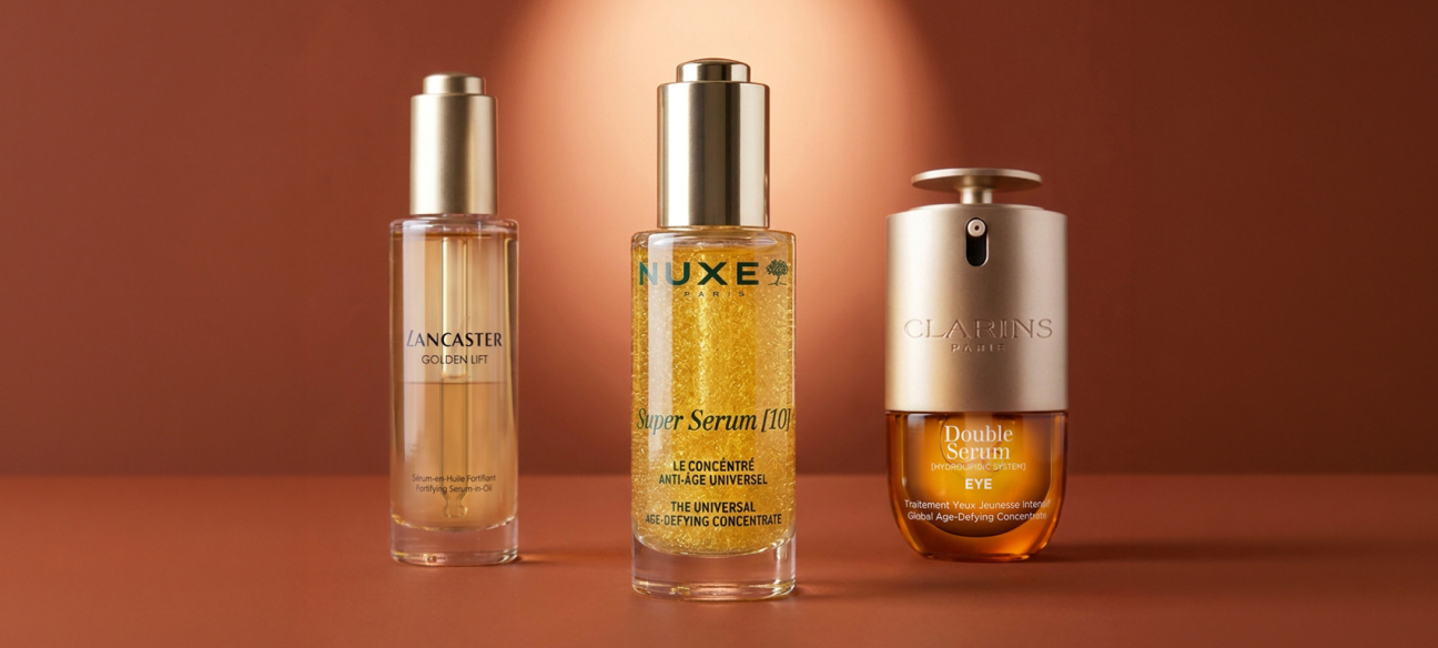 Sieri anti-aging Lancaster, NUXE e Clarins su sfondo viola, per una skincare ad alte prestazioni.