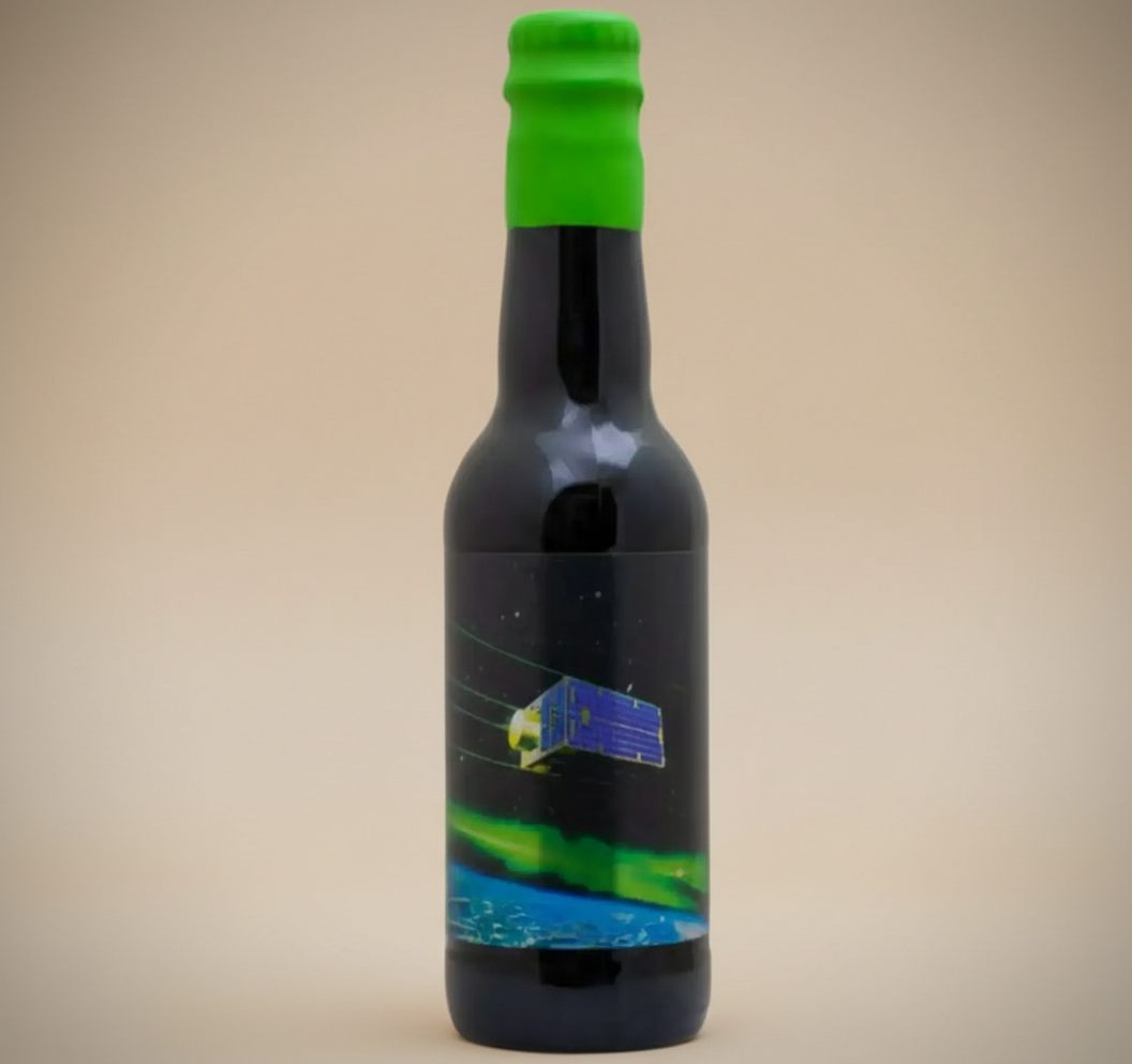 A dark bottle with a green cap and a label depicting a satellite over Earth.