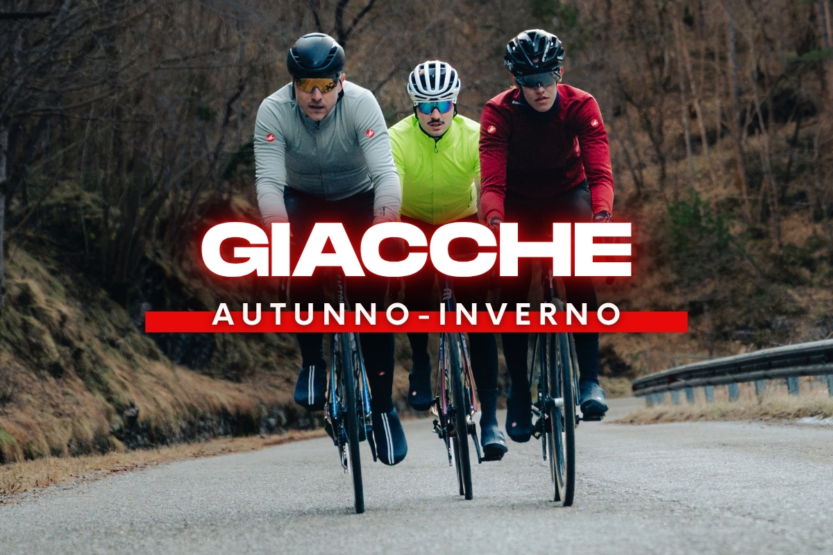 Three cyclists riding on a damp country road wearing autumn-winter cycling jackets (hi‑vis yellow, grey, red) with a bold 'GIACCHE' banner overlay