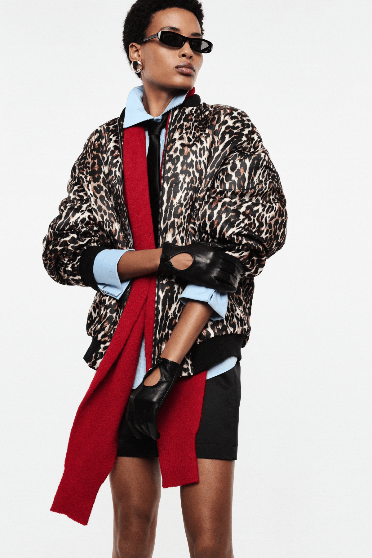 Collage of a model in leopard-print jacket, red scarf, black skirt, heels and sunglasses in multiple poses