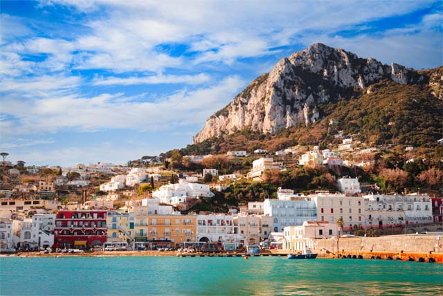 Scenic view of Capri harbor with colorful buildings.