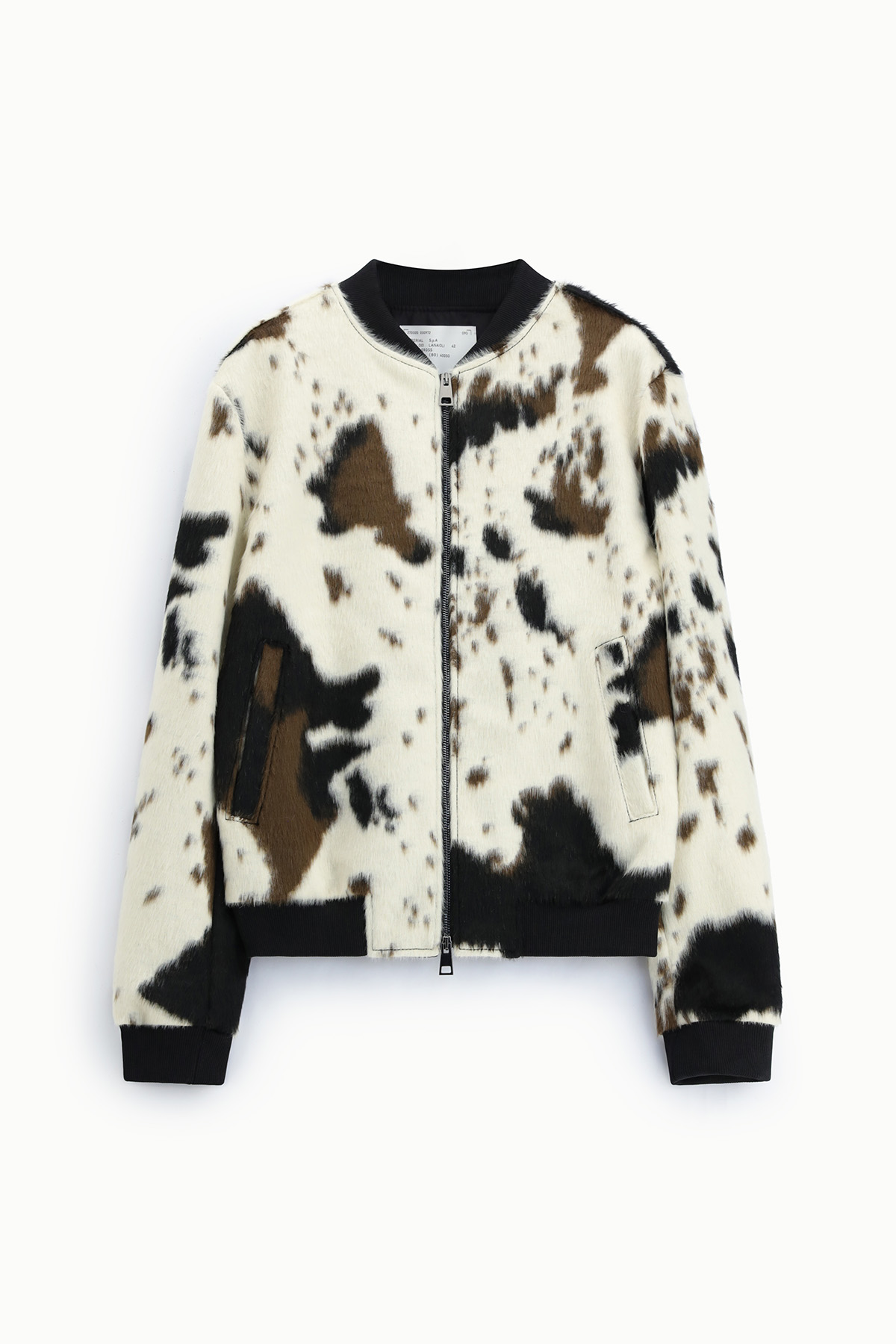 Faux fur bomber jacket with black, brown and white cowhide print, full front zip and ribbed collar, cuffs and hem