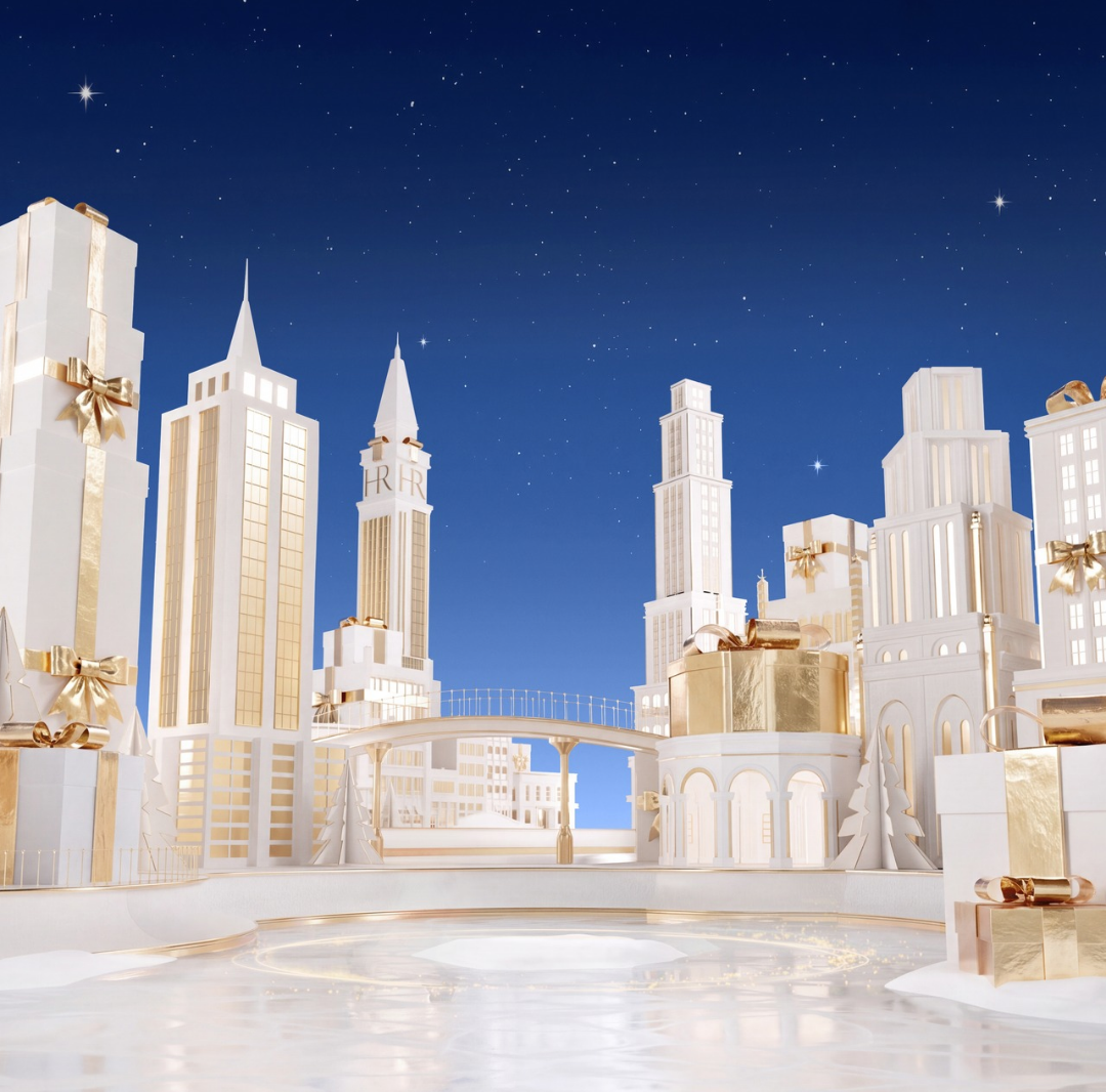 Scena festiva bianca e dorata che rappresenta la citt&agrave; di New York e la sua pista di pattinaggio, illuminata sotto un cielo stellato