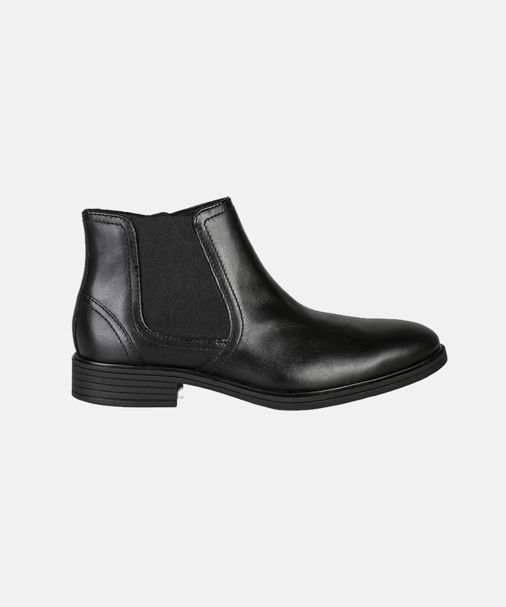 Black leather Chelsea boot side view with elastic side panels and low stacked heel on white background