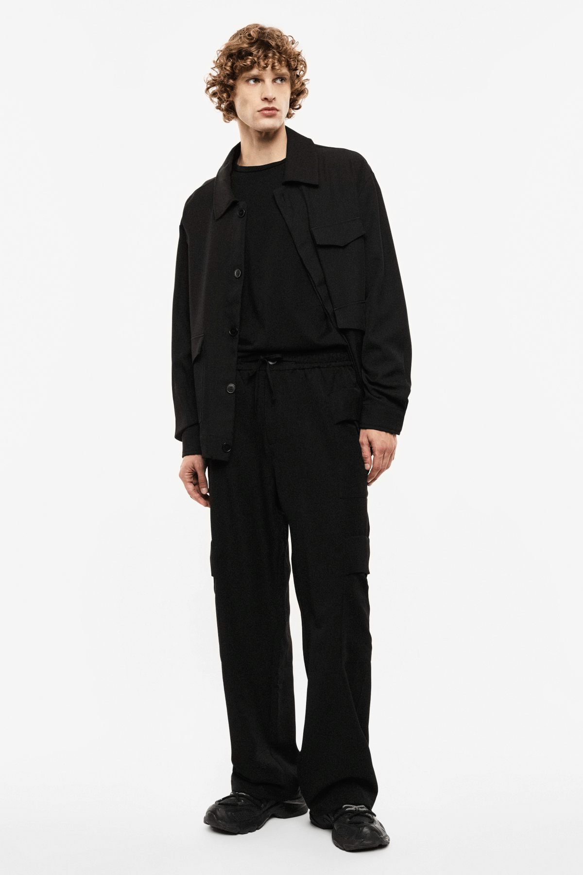 Grid of nine photos showing a male model in a black jacket and trousers, front, back and side views on a white background