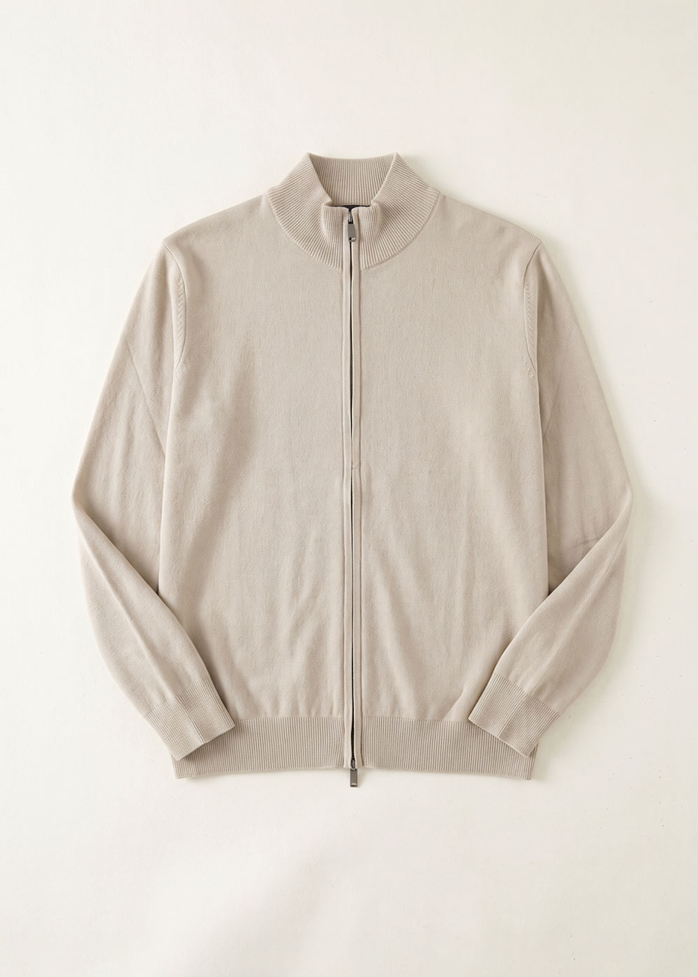 Lightweight beige knitted full-zip cardigan with ribbed collar, cuffs and hem laid flat on white background