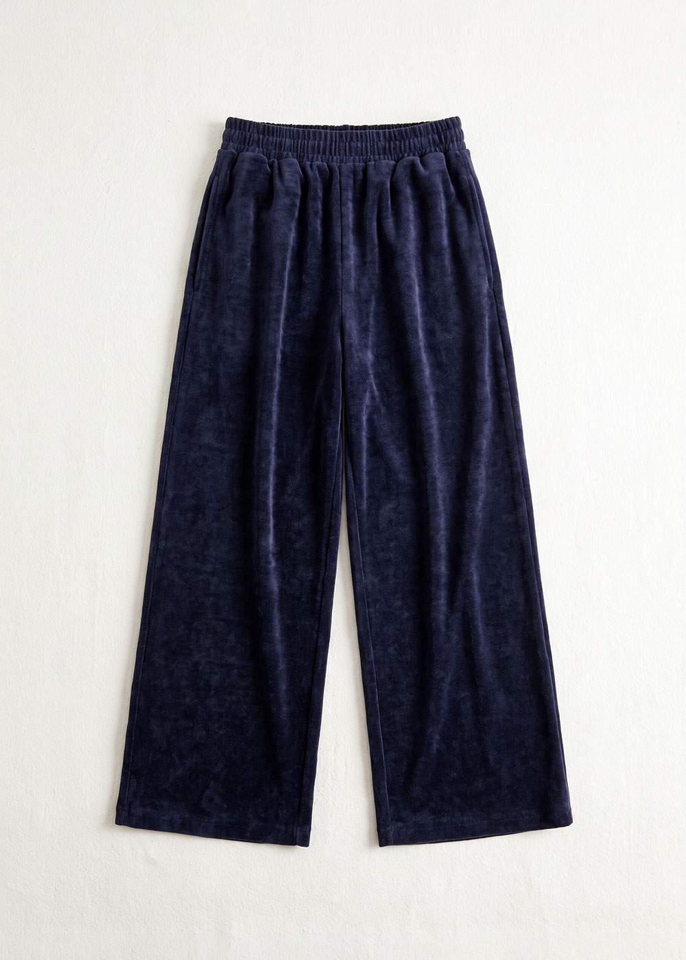 Navy velour wide‑leg lounge trousers with elastic waistband, flat‑lay on white background