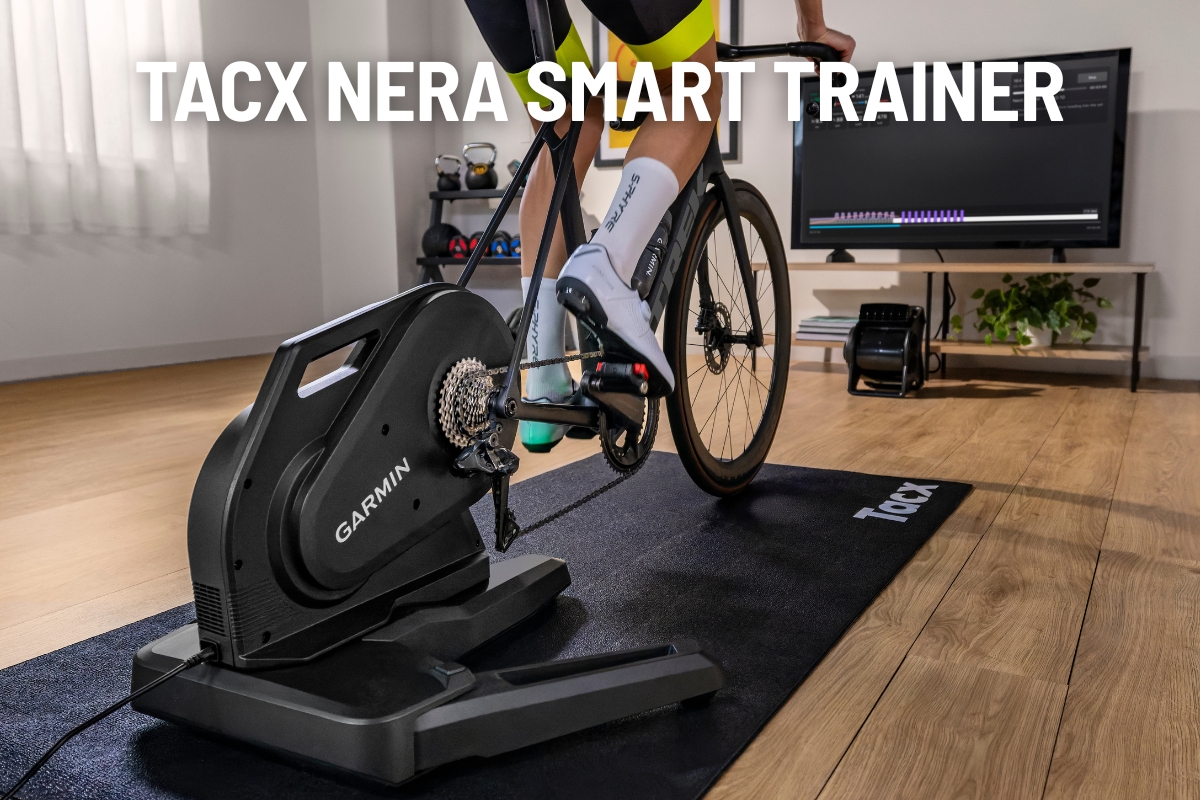 Cyclist using Tacx Nera smart trainer (Garmin) on a road bike indoors on a trainer mat with TV displaying training app